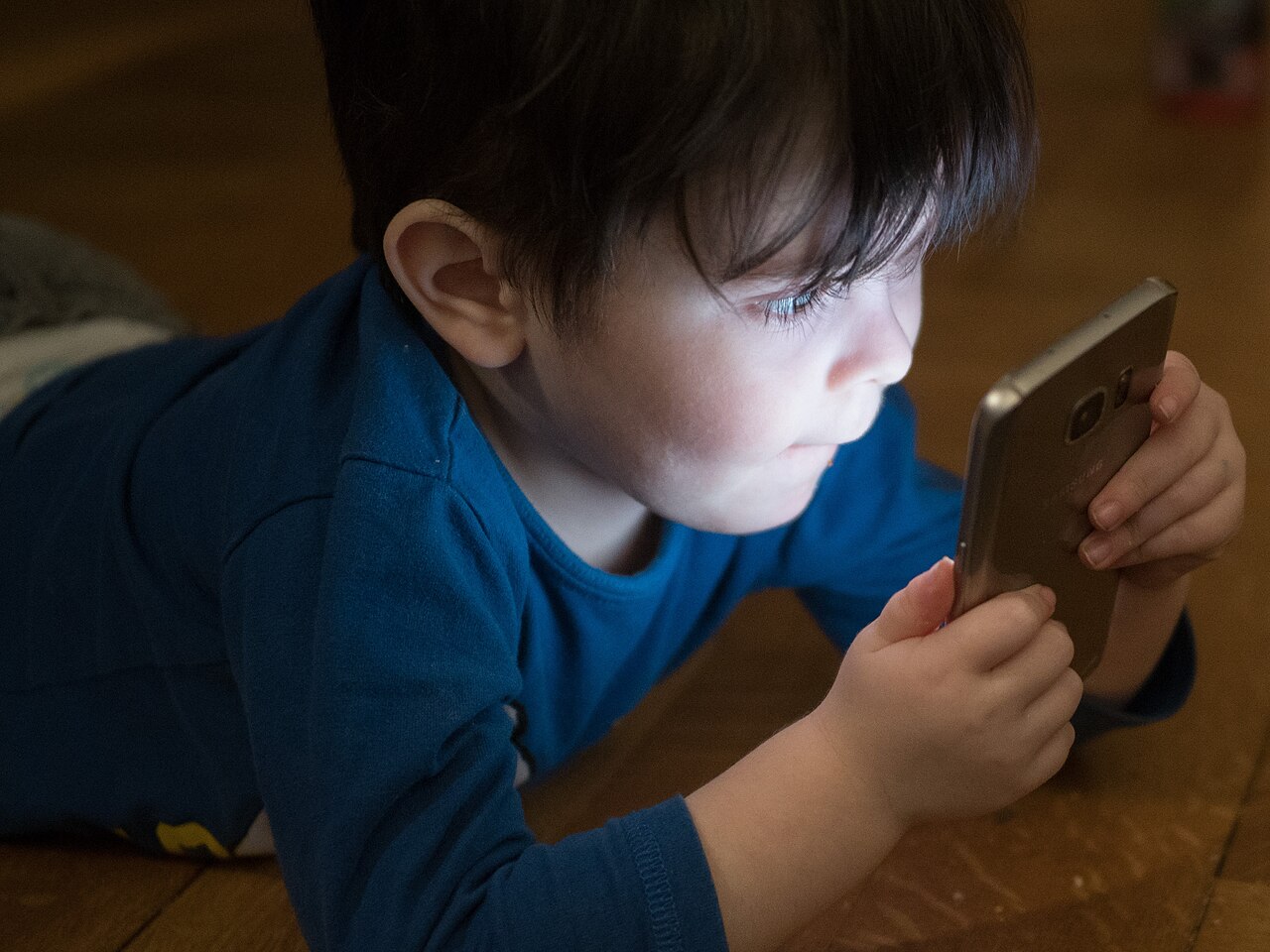A child using a smartphone at close range
